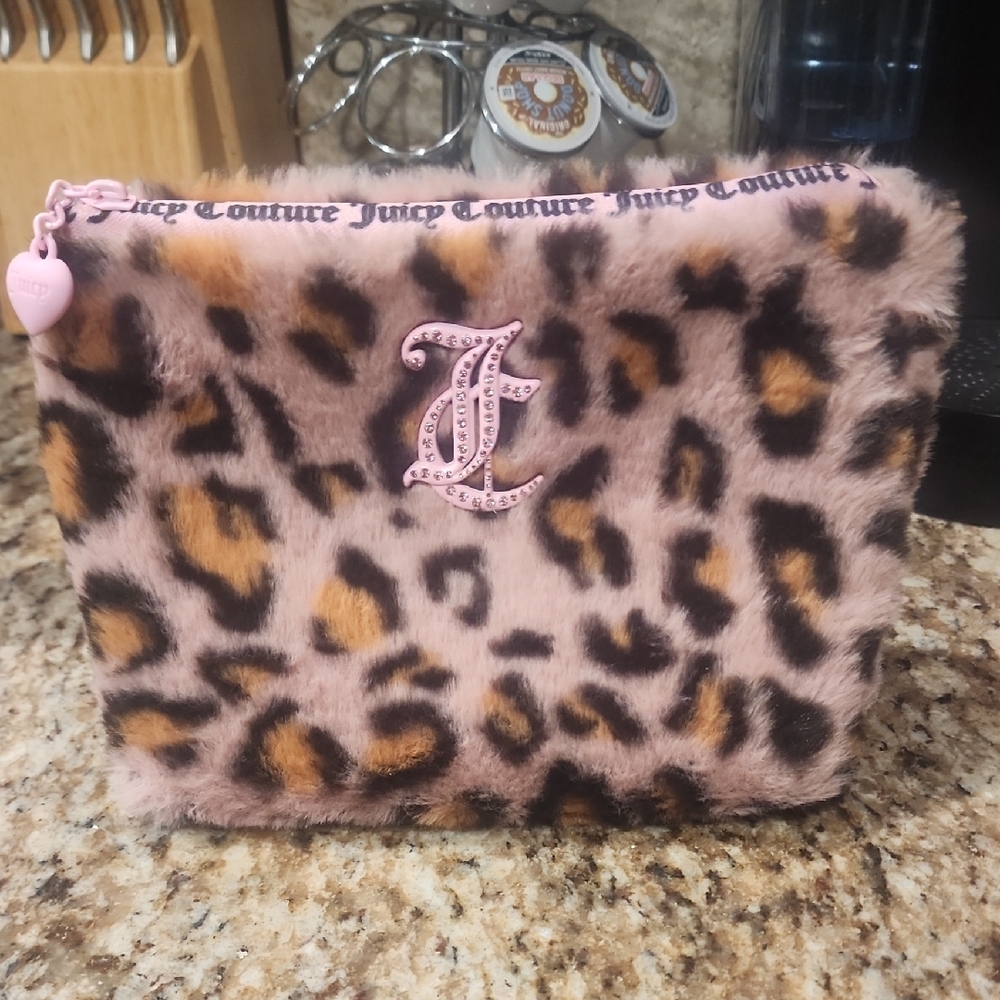 Juicy Couture Faux Fur Leopard Pouch with Pink Accents And Plastic Bottle.
